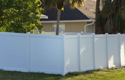 White plastic fence for back yard protection and privacy.